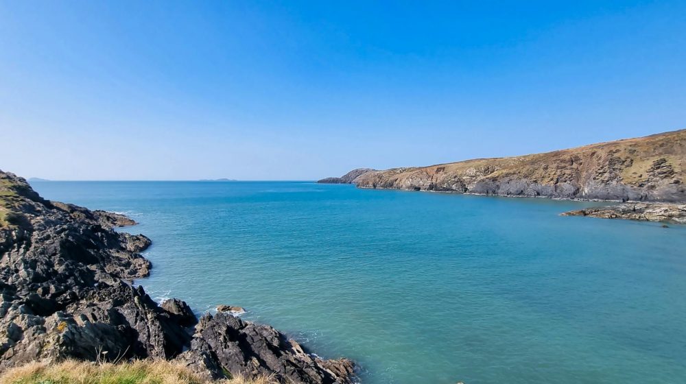 blue sea seen from rocky shore