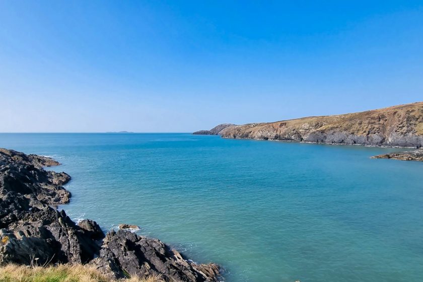 blue sea seen from rocky shore